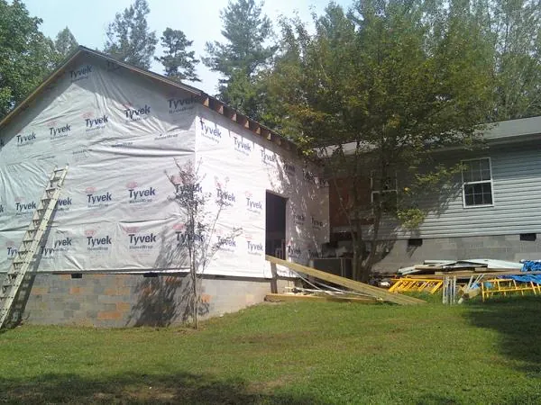 Tyvek wrapped gable on a new room addition beside an existing home in Pitsburg