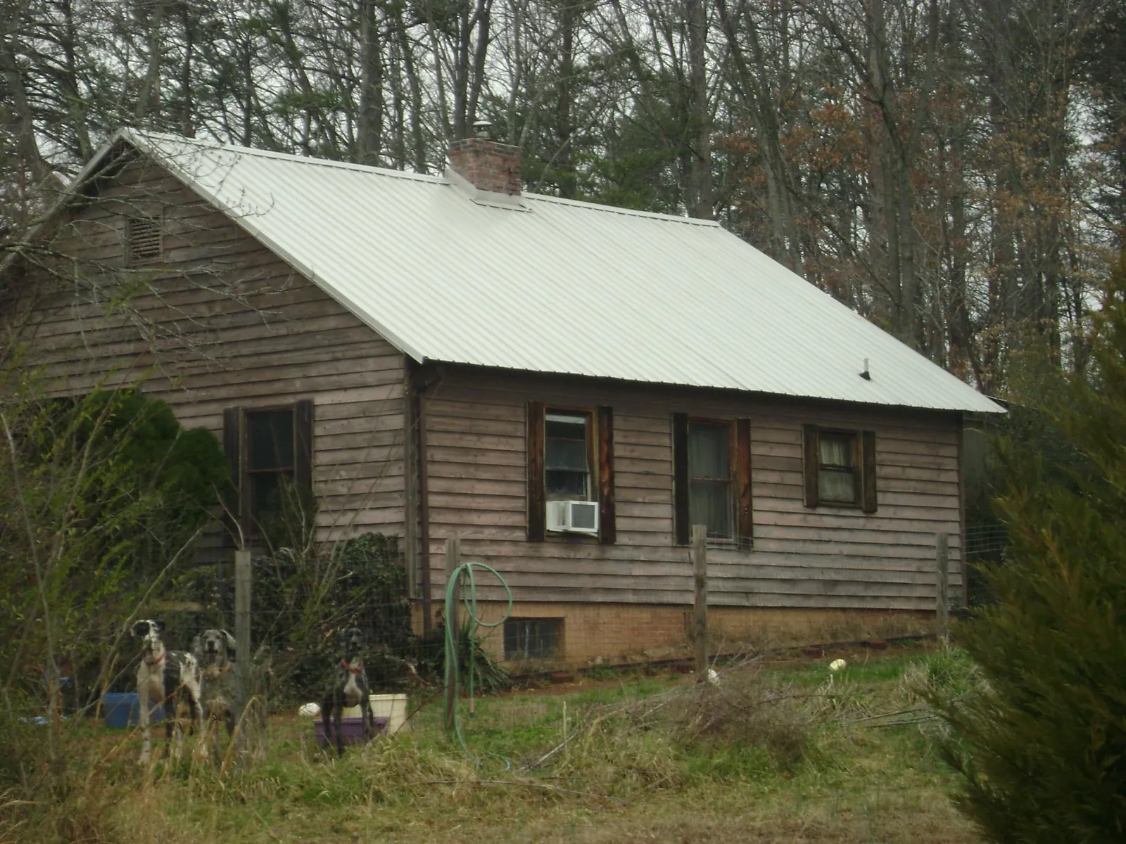 White metal roof on an old wood sided farmhouse, from a Metal Roof Installation job in Pitsburg